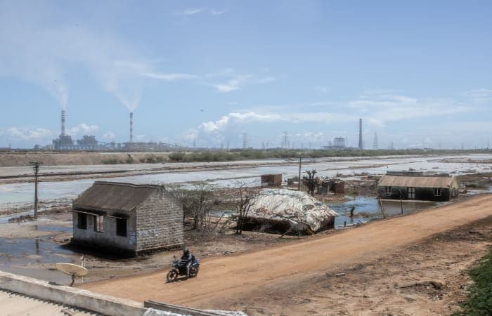 Abandoned homes of families forced to relocate due to coal ash pollution stand flooded by ash slurry in Sepakkam, Ennore, Tamilnadu | Photo: Ishan Tankha, Clean Air Collective